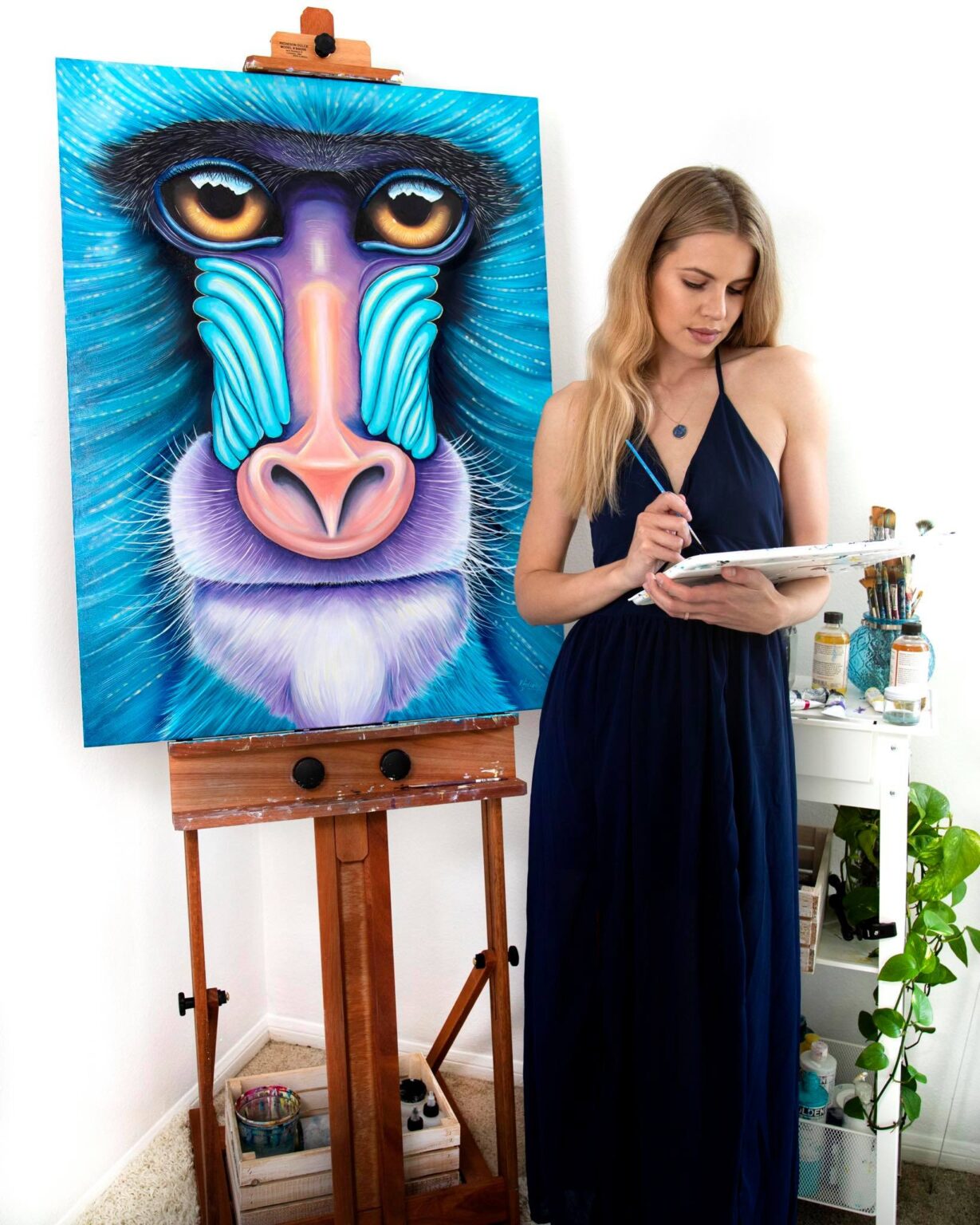 Ekaterina Sky with her oil painting of a mandrill, Animalize Primates