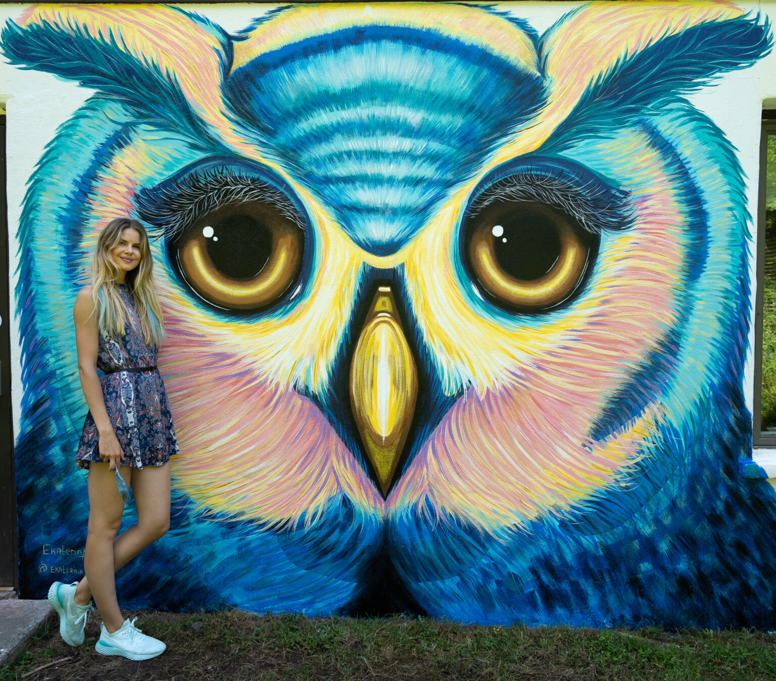 Ekaterina Sky in front of her barn owl mural in upstate New York