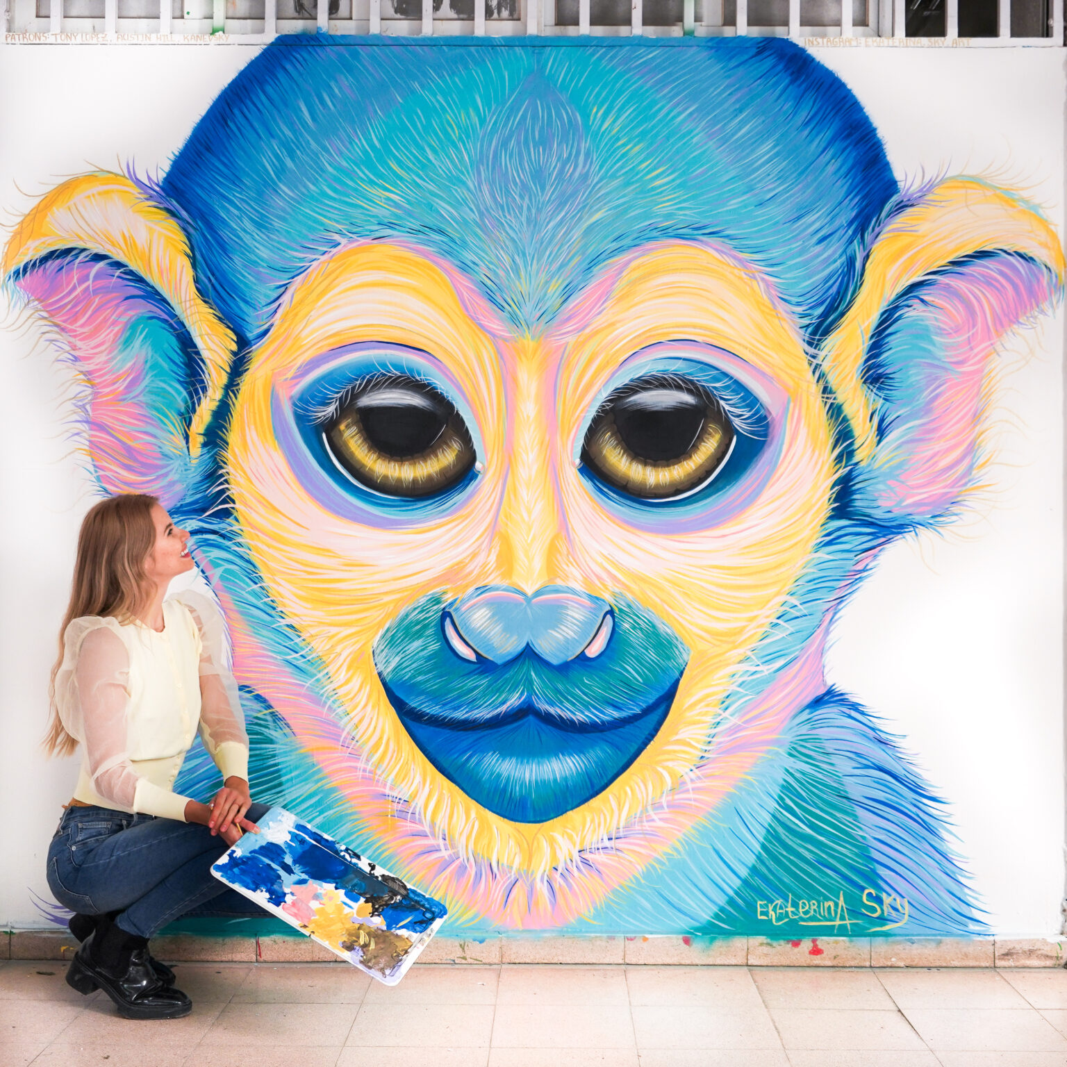 Ekaterina Sky with her monkey mural in Tel Aviv, Animalize World Mural Tour