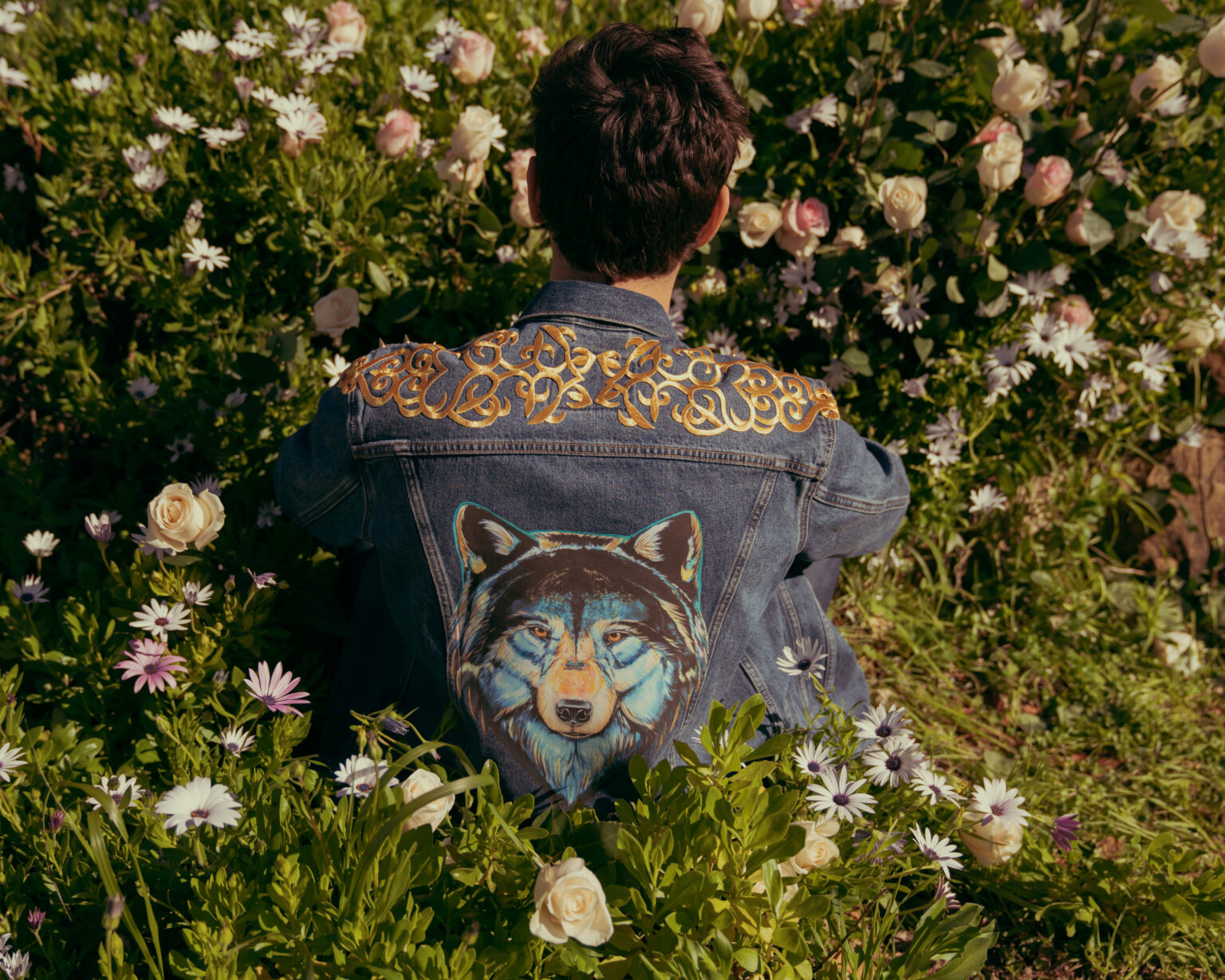 Back of an Animalize capsule denim jacket with a wolf painting